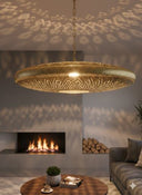 Exotic Moroccan brass pendant light glowing with warm amber in boho room – Brass For Homes